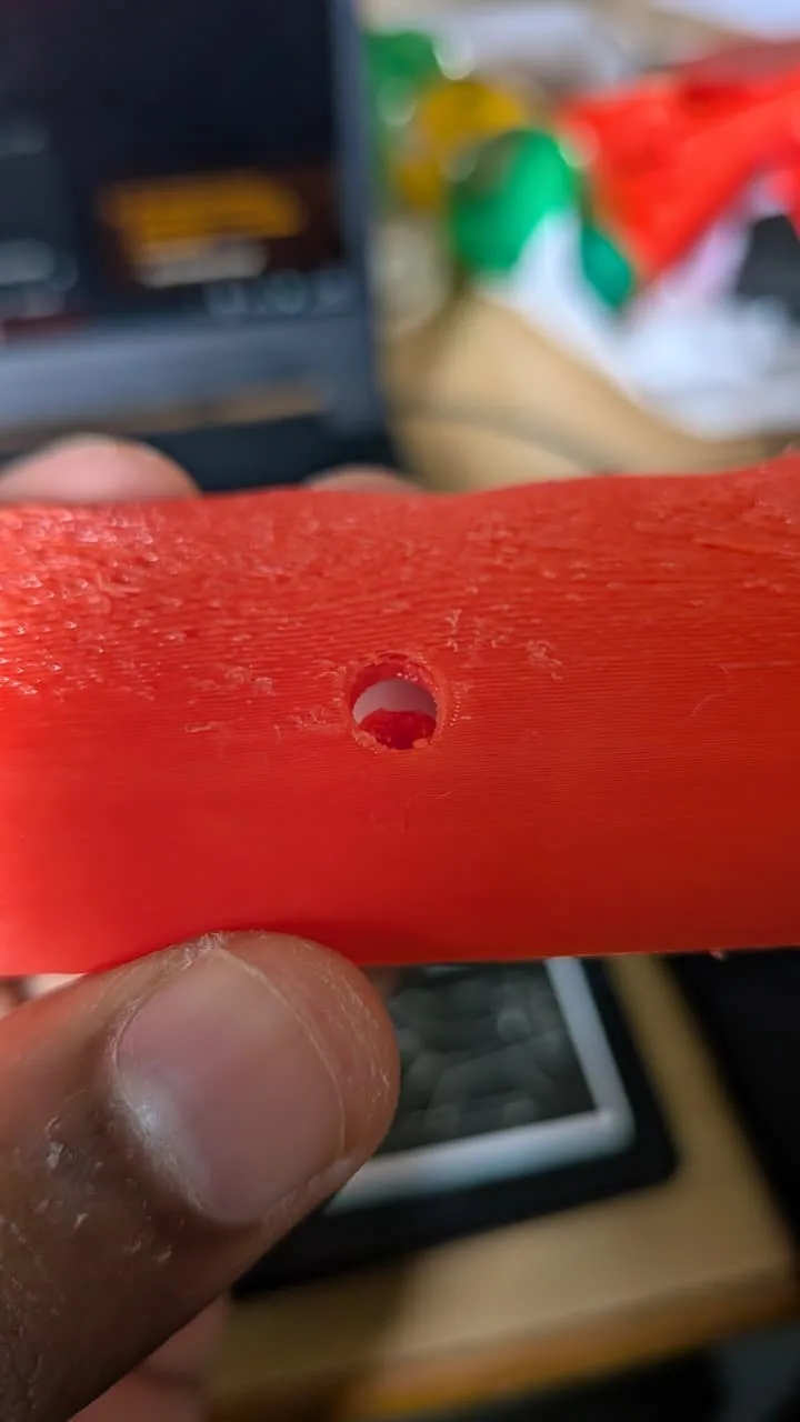 First PLA fit-test print, held in the hand: the grip half from outside, showing the screw-head pocket